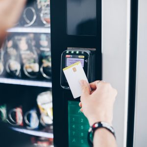 Student using the contactless payment method in a vending machine.
